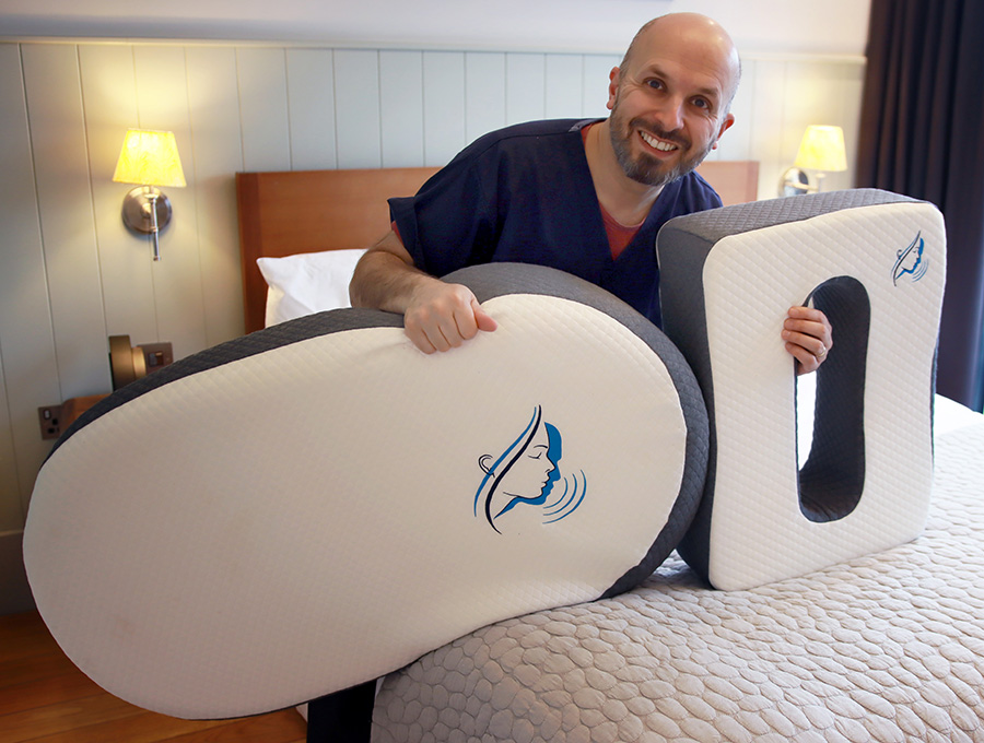 Professor Vik Veer holding the Side Sleep Pro pillow